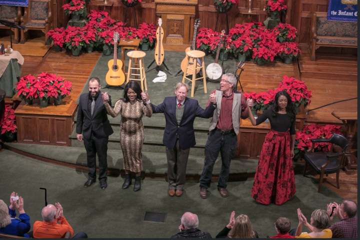 Musicians holding hands on stage