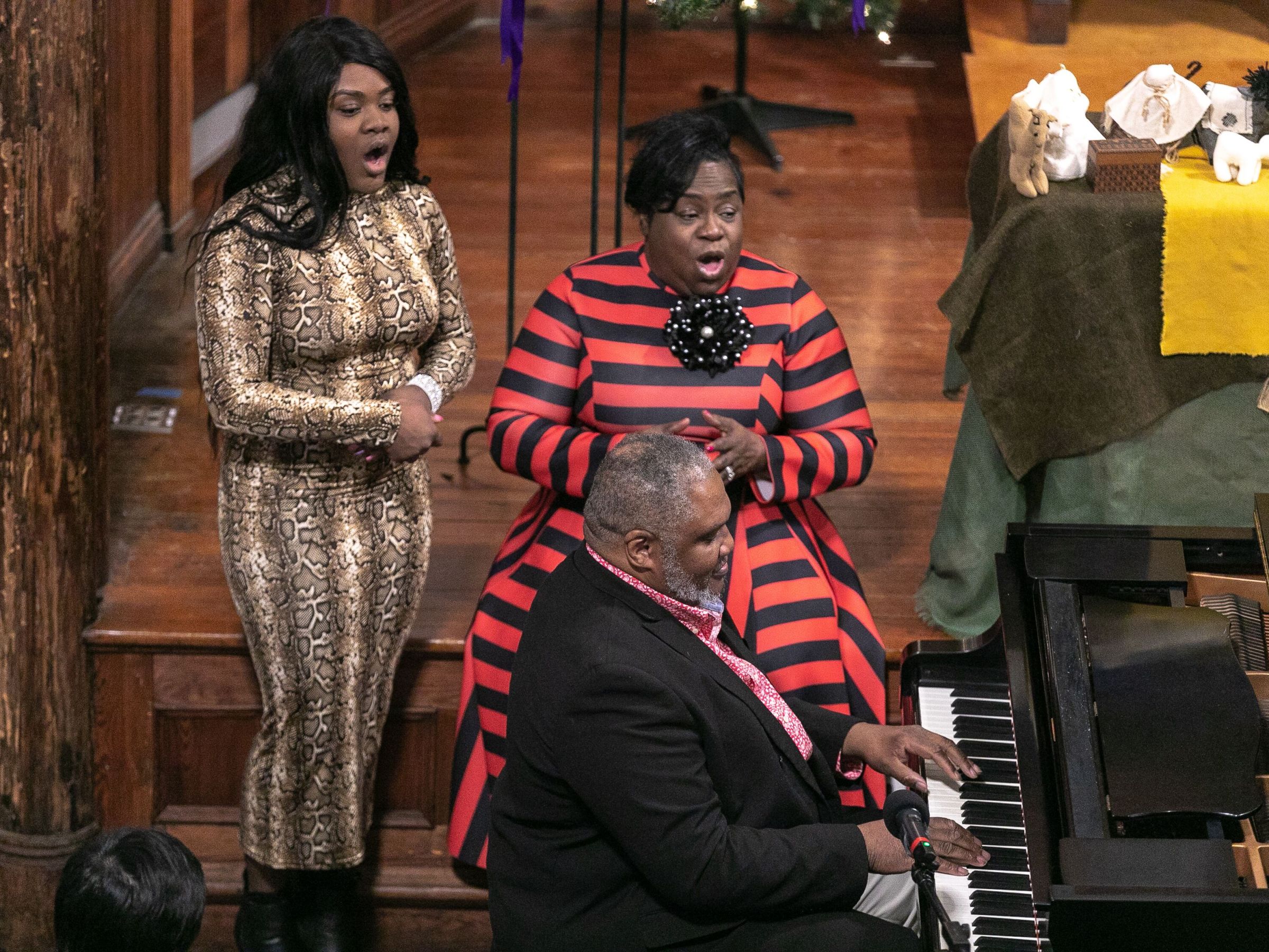 Ladies singing, man playing the piano